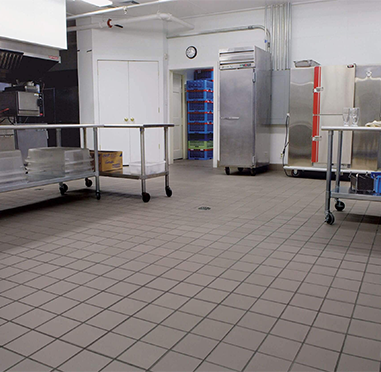 Commercial kitchen cooking area with stainless steel wall